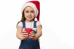 可爱的婴儿女孩圣诞老人他基斯红色的蜡烛手可爱的孩子使珍惜圣诞节复制空间