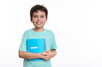 可爱的青少年小学生蓝色的衬衫持有<strong>字帖</strong>微笑快乐的露出牙齿的微笑相机回来学校