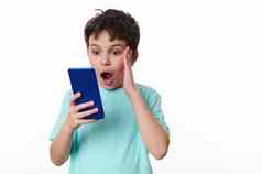 震惊了高加索人十几岁的男孩移动电话孤立的白色背景复制广告空间文本