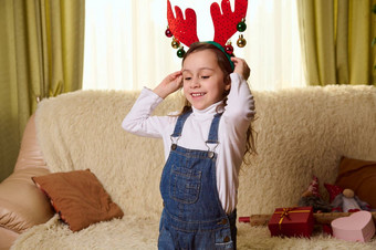 快乐可爱的<strong>孩子</strong>女孩有趣的舒适的首页室内<strong>圣诞</strong>节假期把鹿鹿角希望