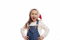 淘气的喜出望外孩子女孩圣诞老人他糖果拐杖微笑相机孤立的白色背景