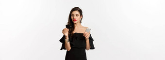 时尚购物概念有吸引力的女人化妆黑色的衣服订单<strong>在线支付</strong>信贷卡移动电话白色背景