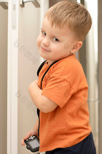 人英俊的有趣的情感高加索人金发碧眼的男孩橙色t恤孩子们的白色相机需要图片首页室内