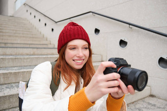 城市人生活方式快乐红色头发的人女人需要照片持有专业数字相机<strong>拍摄</strong>街道