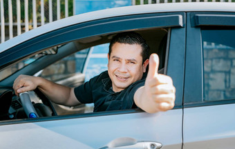 快乐司机给拇指满意司机男人。显示拇指概念满意车老板男人。车给拇指