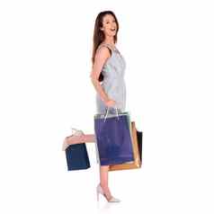 妍购物狂肖像年轻的女人携带购物袋孤立的白色