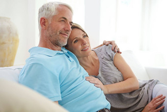 夫妇拥抱思考未来退休首页爱护理支持承诺男人。女人健康的婚姻信任生活保险安全生活房间沙发上