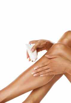 腿手女人奶油产品工作室白色背景护肤品化妆化妆品女模型应用乳液保湿霜噪音管美健康的皮肤健康