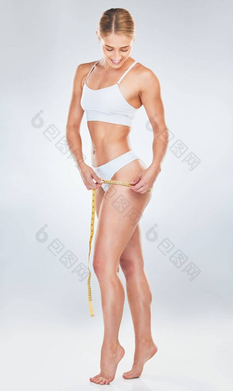 身体腿磁带测量女人工作室灰色的背景测量<strong>减肥</strong>法<strong>健身</strong>锻炼健康有吸引力的年轻的女跟踪饮食生活方式进步