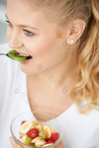 享受富含维生素的零食特写镜头有吸引力的年轻的女人吃水果沙拉
