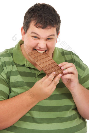 用力地巧克力肥胖年轻的男人。咬板巧克力白色背景