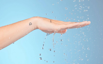女人清洁手水飞溅淋浴美健康的护肤品个人卫生健康蓝色的背景特写镜头水滴洗手棕榈身体浴室