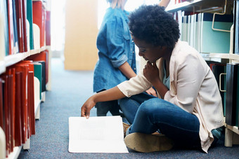 填鸭式一分钟知识年轻的女人坐着地板上阅读图书馆