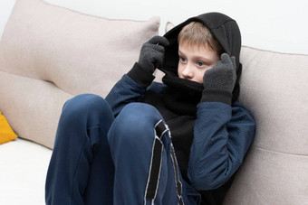 人能源危机概念十几岁的男孩坐在首页沙发上手套罩<strong>冻结</strong>由于加热转战争欧洲能源危机乌克兰