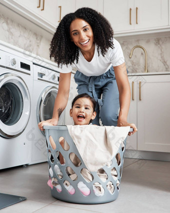 快乐妈妈。孩子洗篮子首页洗衣幸福做家务肖像年轻的女人有趣的女孩孩子清洁房子