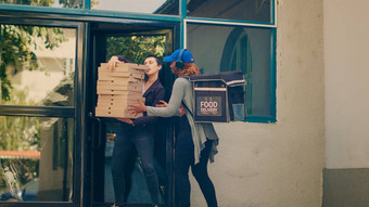 女交付工人携带桩披萨盒子