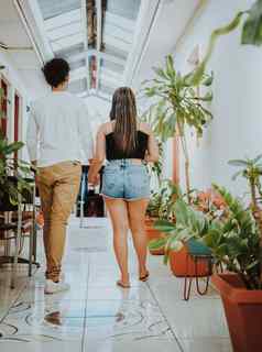 年轻的夫妇走走廊热带酒店微笑快乐夫妇走酒店走廊
