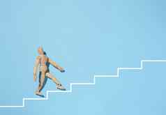 木人体模型画白色楼梯蓝色的背景概念实现目标克服障碍