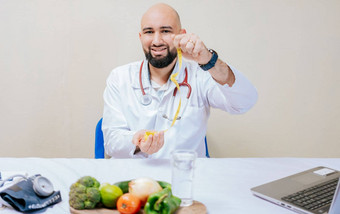 营养学家桌子上持有磁带测量年轻的医生营养学家桌子上持有测量磁带饮食营养概念