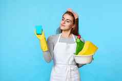 女人橡胶手套清洁蓝色的海绵瓶洗涤剂