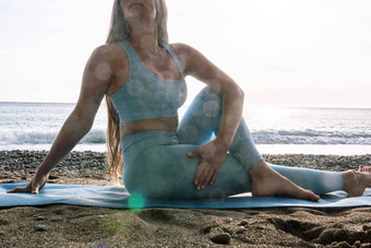 女人海普拉提运动快乐中间岁的女人练习健身海滩海微笑活跃的女培训瑜伽席享受健康的生活方式和谐冥想