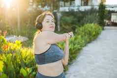 可爱的脂肪女人运动服订婚了健身户外一边视图肖像复制空间年轻的超重女人弓步在户外温暖的夏天一天健康的生活方式重量损失