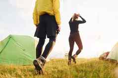 夫妇走在户外绿色帐篷概念旅行