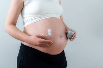 怀孕了女人应用白色奶油肚子采取护理皮肤