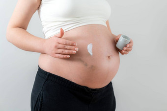 怀孕了女人应用白色奶油肚子瘀伤注射采取护理皮肤