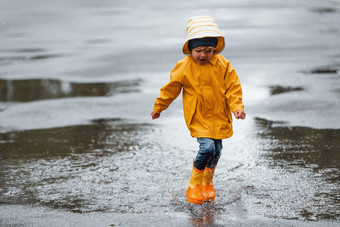 孩子黄色的<strong>防水</strong>斗篷靴子玩在户外雨