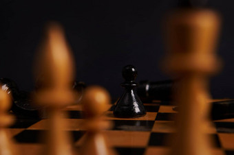 焦点黑色的木国际象棋一块爪子移动模糊前景白色块孤立的黑色的背景