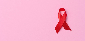 丝绸红色的丝带形式弓粉红色的背景象征战斗<strong>艾滋病标志</strong>团结支持