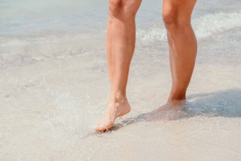海海滩旅行女人走<strong>沙子</strong>海滩离开的足迹白色<strong>沙子</strong>女腿走<strong>海边</strong>光着脚特写镜头晒黑腿女孩未来水