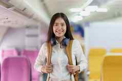 美丽的亚洲旅行者女人背包飞行着陆旅行飞机概念