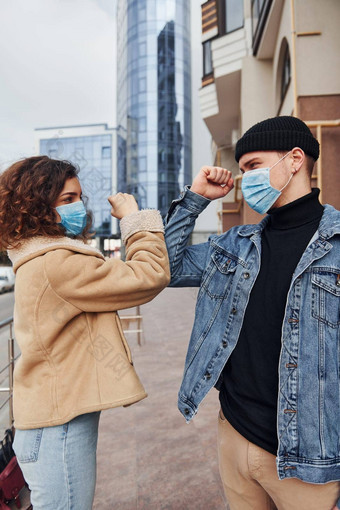 夫妇保护面具问候城市业务建筑检疫时间概念冠状病毒