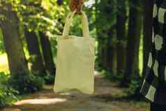 特写镜头认不出来女手持有棉花生态袋公园可重用的生态袋公园模拟可持续发展的生活方式塑料免费的浪费免费的生活绿色