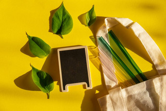 可重用的玻璃吸管色彩斑斓的背景绿色树叶生态袋<strong>环保</strong>空黑板上模拟<strong>模板</strong>复制空间文本喝稻草集可重用的舒适的圆形的提示喝稻草浪费塑料免费的概念野餐概念