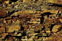 石头棕色（的）金黄色的摇摇欲坠岩石背景