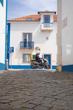 食物交付摩托踏板车司机黄色的背包回来交付食物葡萄牙街道葡萄牙