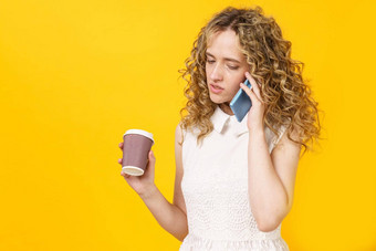 肖像年轻的女人在情感上会说话的电话喝咖啡女肖像
