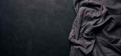 折叠黑色的亚麻亚麻厨房毛巾黑色的背景前视图复制空间
