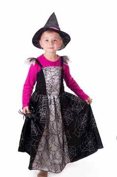女巫女巫化妆舞会女孩万圣节服装持有黑色的玩具蜘蛛手白色背景