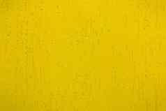 光明亮的黄色的油漆颜色贴墙表面摘要粉刷模式设计纹理背景