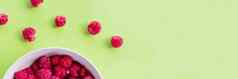 红色的树莓浆果板绿色表格水果浆果背景夏天食物饮食维生素素食主义者食物有机自然健康的零食复制空间网络横幅