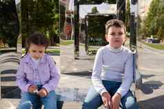 肖像可爱的小学岁的孩子们男孩女孩哥哥妹妹坐着镜子板凳上城市公园