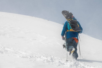 男人。滑雪设备滑雪板爬<strong>雪山蓝色</strong>的<strong>天空雪山</strong>背景