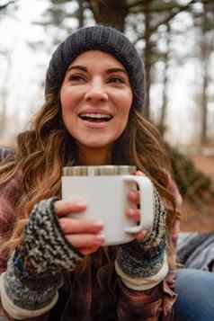 杯幸福运行空年轻的女人喝温暖的饮料野营荒野冬天
