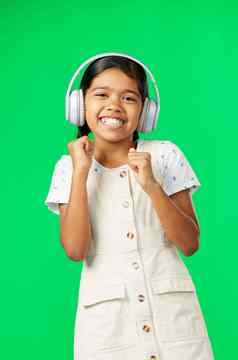 孩子们音乐跳舞女孩绿色屏幕背景工作室流媒体音频肖像微笑有趣的可爱的女孩跳舞听广播耳机