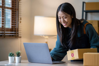 年轻的快乐亚洲女人移动PC屏幕庆祝出售微笑年轻的企业家快乐出售成功的