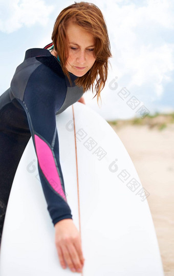等待打击水年轻的女冲浪者准备好了享受波热萨默斯一天